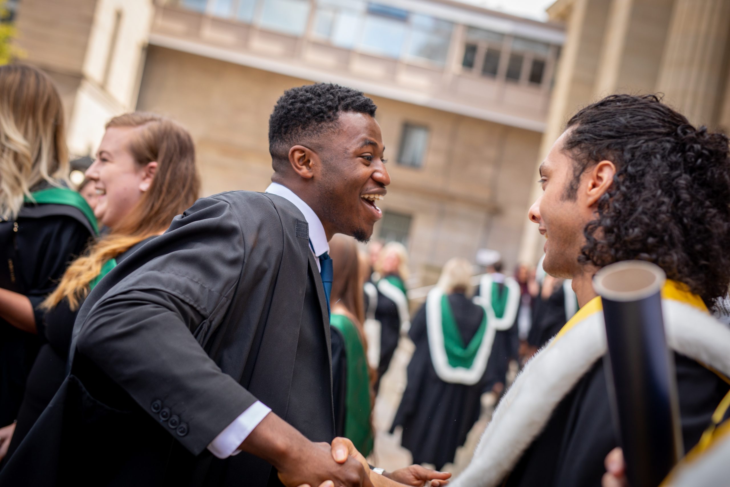 Graduates shaking hands